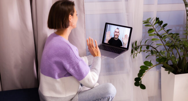 Woman at home face time video call her friends husband boyfriend, chatting online from laptop Woman at home face time video call her friends husband boyfriend, chatting online from laptop